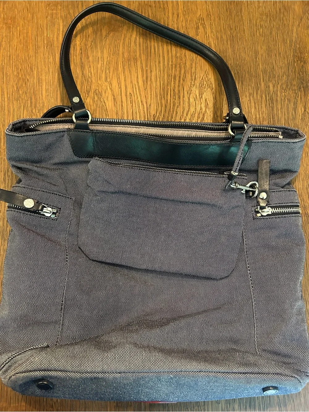 MZ Wallace navy canvas tote with leather pocket and handles